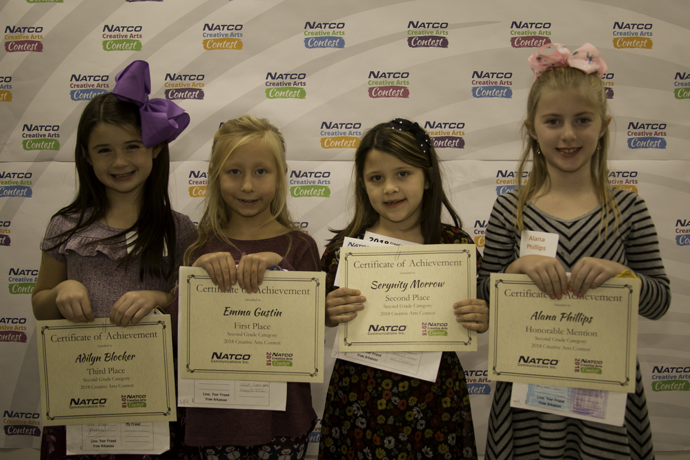 Group of 4 award winners holding their certificate