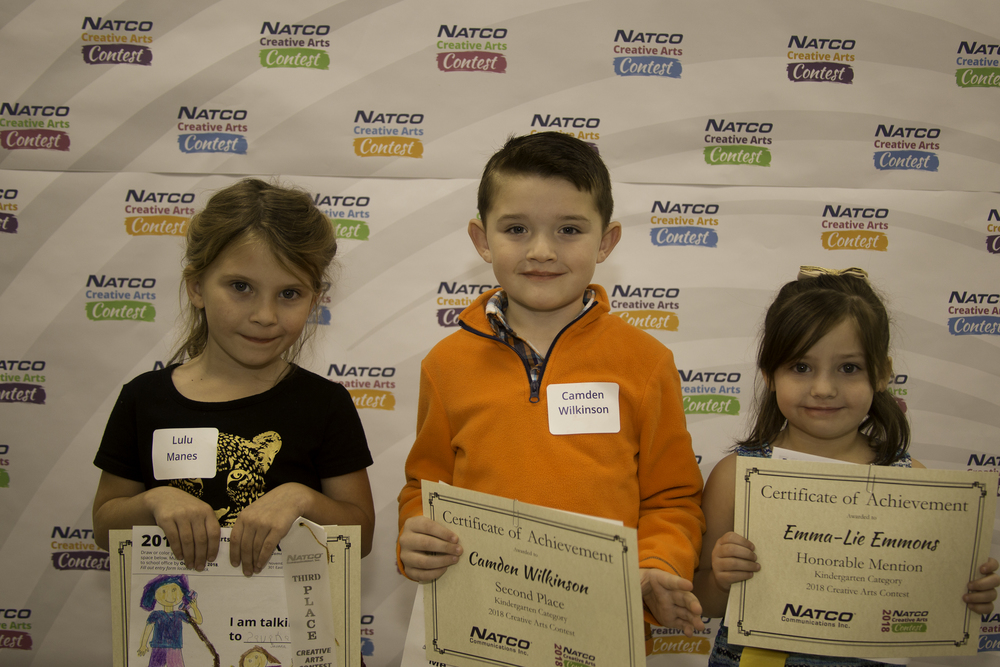 3 children holding award certificate