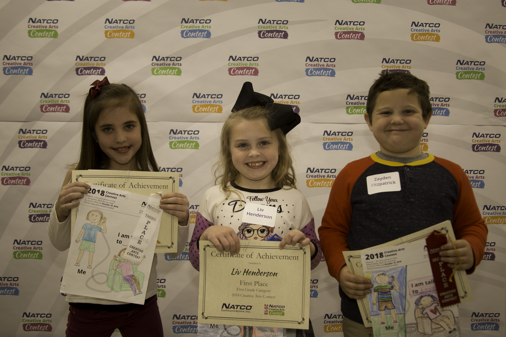 3 children holding certificates from natco